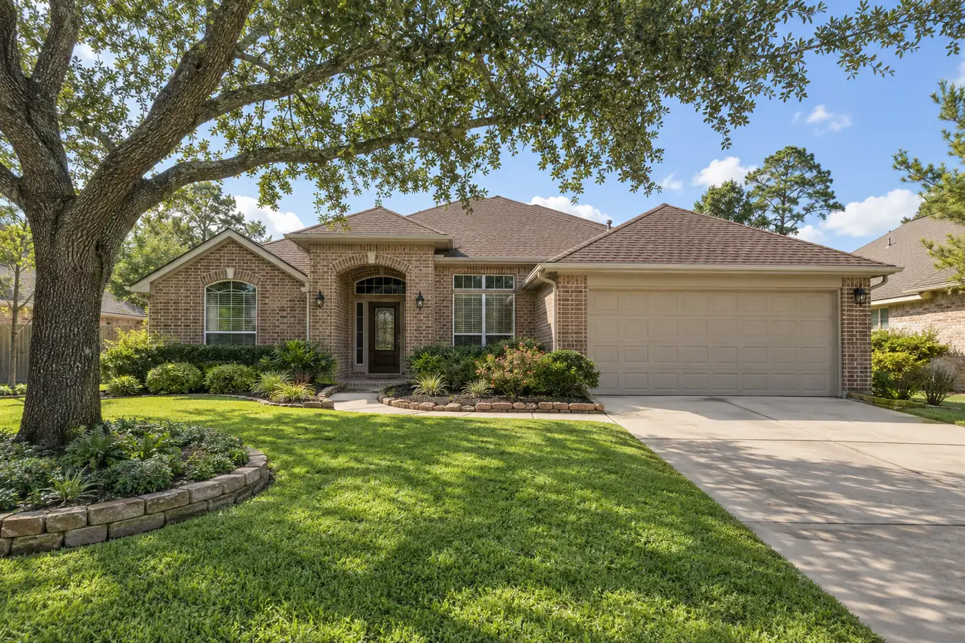 Suburban home with an asphalt shingle roof under pines, a stand-in scene